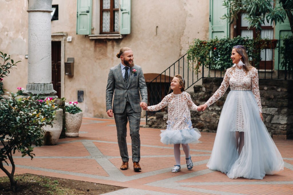 a happy young family walks through the old town of utc