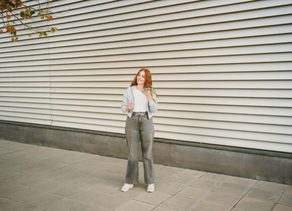 a stylish young woman confidently poses against a utc