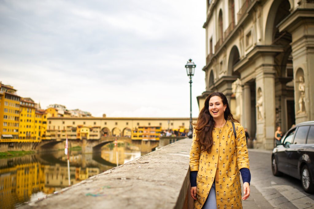 a tourist girl with an orange coat happily walks o utc