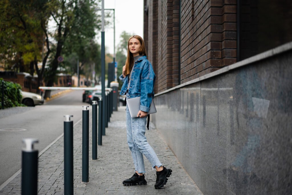 beautiful blonde student girl smiling and holding utc
