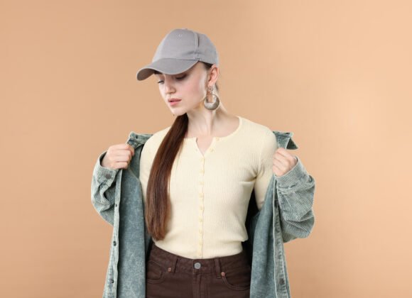 beautiful woman in stylish baseball hat on beige b utc