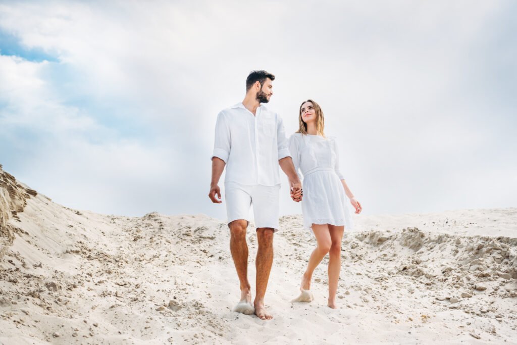 beautiful young couple in white clothes walking by utc