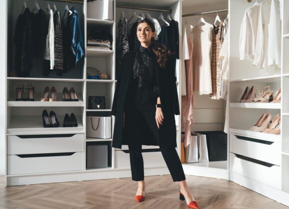 cheerful stylish woman standing in wardrobe utc