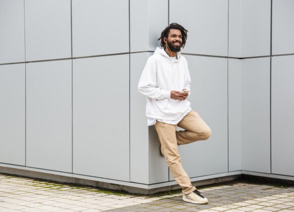 cheerful young man with earphones utc