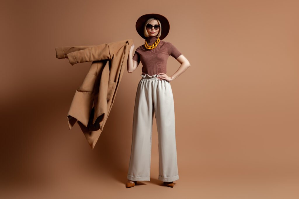 fashionable young woman in elegant hat carrying he utc