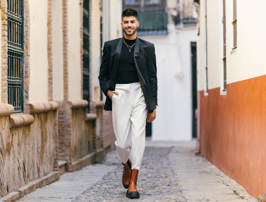 handsome male smiling while walking on the street utc
