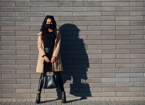 in protective mask beautiful brunette with curly utc