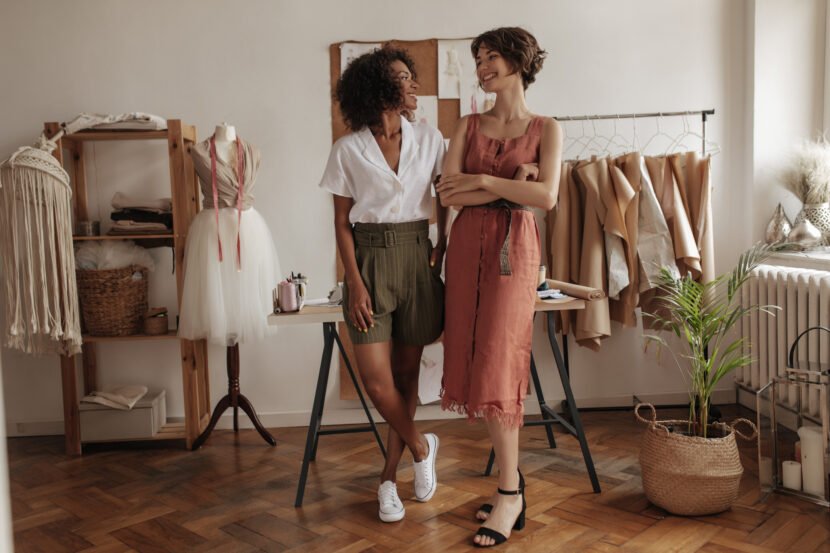 joyful young women pose in cozy office of fashion utc