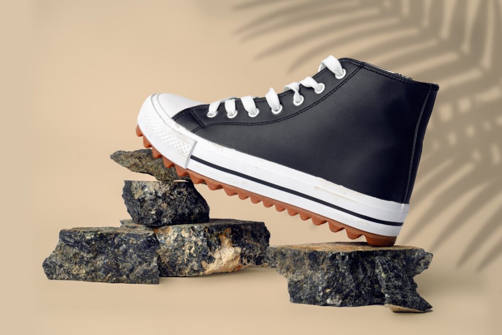 new sneaker shoe on stones on beige studio backgro utc