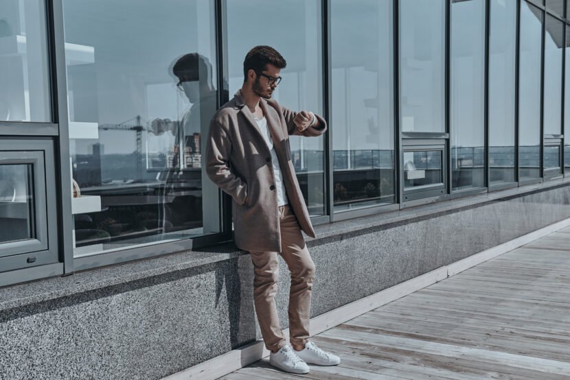 Punctuality is a way to success.  Full length of serious young m