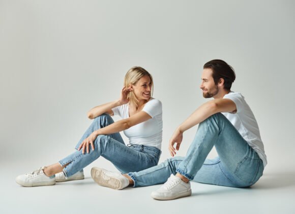 serene lovebirds in jeans sitting and looking at e utc