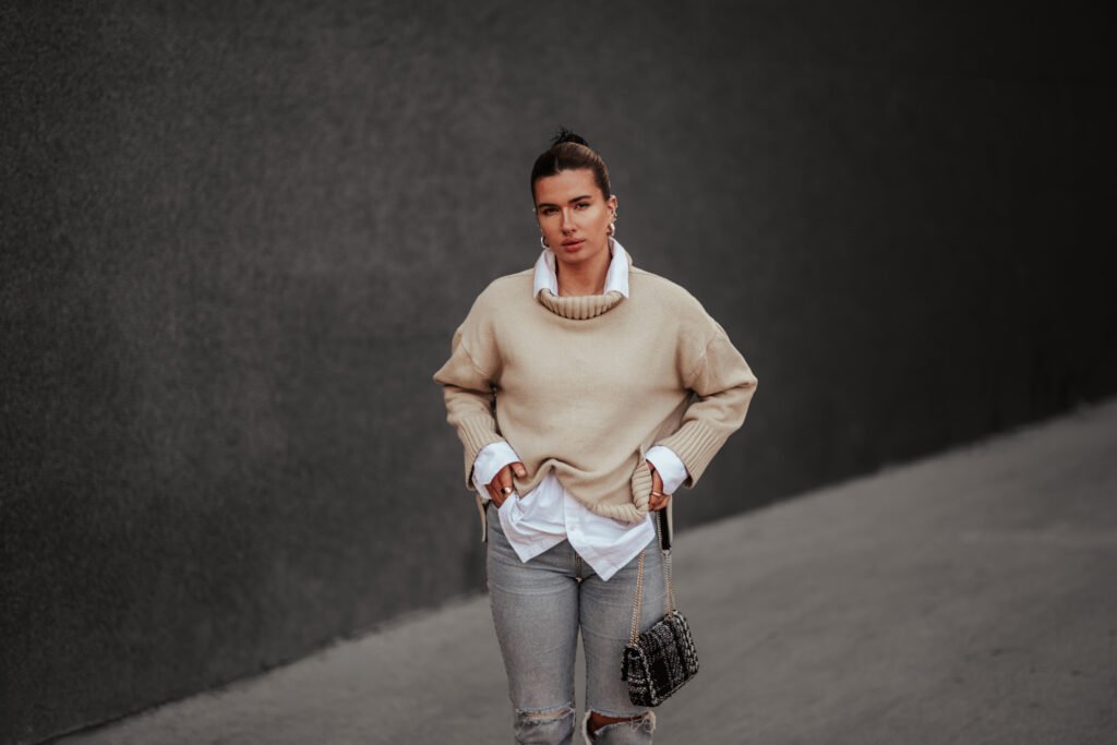 smart casual woman wearing sweater with hands in h utc