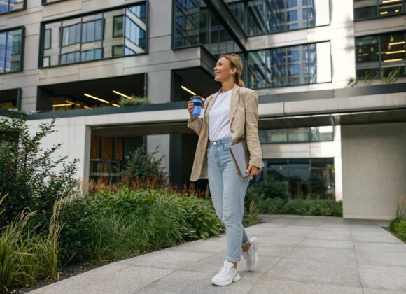 smiling female freelancer with laptop and take awa 2026 03 10 01 10 01 utc scaled