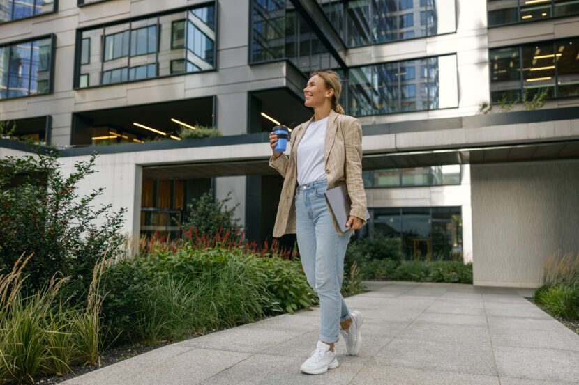 smiling female freelancer with laptop and take awa 2026 03 10 01 10 01 utc scaled