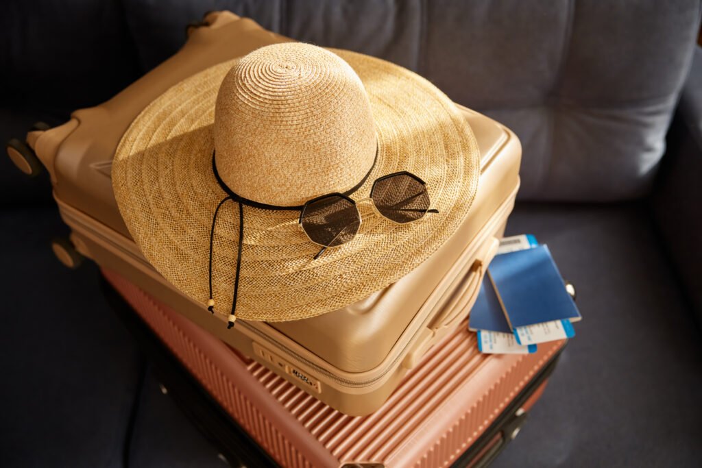 stacked travel suitcase with straw beach hat sung utc