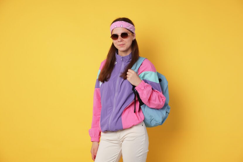 teenage girl in sunglasses with backpack on yellow utc