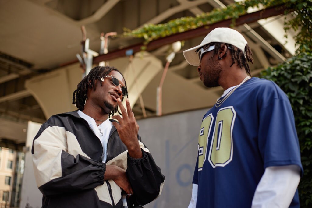 young adult black men socializing outdoors under u utc