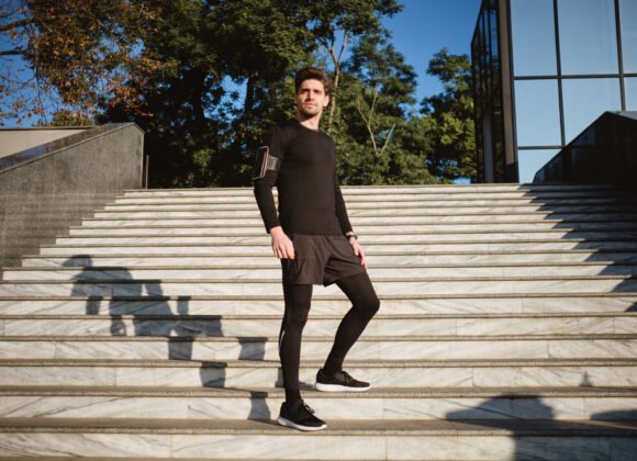 Young handsome confident sporty man thoughtfully looking away on